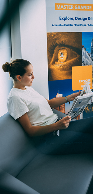 A student flips through the newspaper
